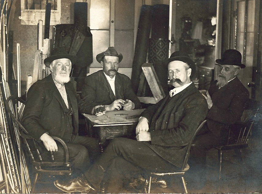 4 men playing dominos